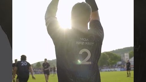 A rugby player with his head raised towards the sun – a still from a video